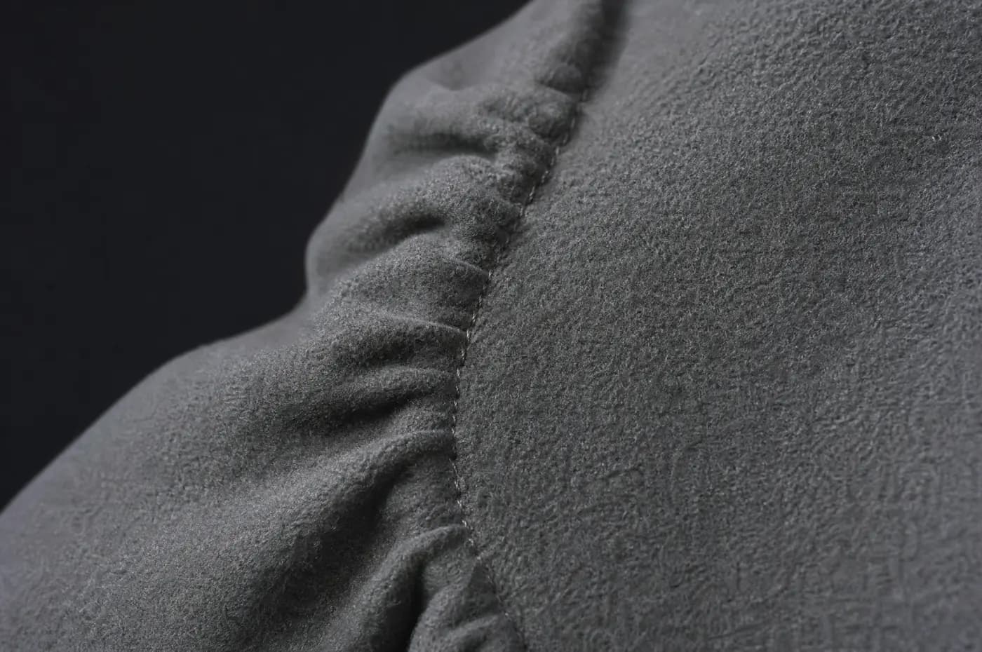 An armhole seam with the sleeve head eased slightly against the body panel.