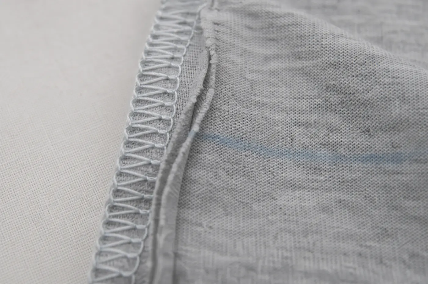 The inside of a side seam finished with looped thread along the raw edge.